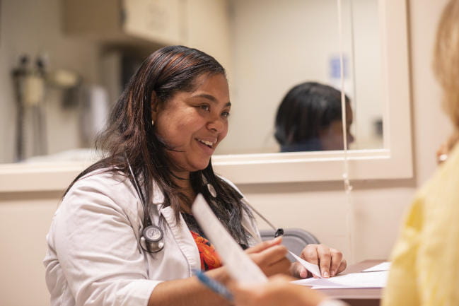 Nurses conferring in clinical setting