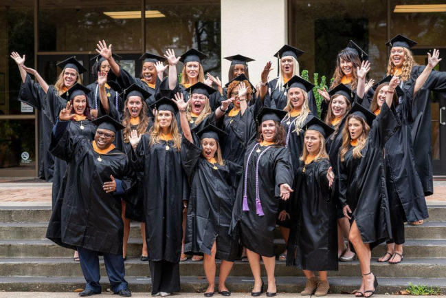 Nursing students pose in academic regalia